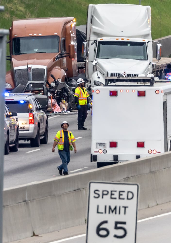 All lanes reopened on I-75 South in Henry County after a six hour investigation of a deadly crash involving multiple tractor-trailers that brought travel to a standstill Tuesday morning, April 16, 2024. The collision happened near mile marker 221, or just past Jodeco Road and before Jonesboro Road, at around 4:40 a.m., according to the Georgia Department of Transportation. The lanes were cleared by 11:20 a.m., GDOT stated, though traffic remained backed up for miles. Henry police confirmed at least one fatality. They did not release additional information about the extent of any other injuries. After the crash, a crane was used to lift a vehicle that appeared to have been pinned under one of the tractor-trailers. Several other big rigs remained on the shoulder of the interstate during the cleanup efforts. Police did not share details about what led to the wreck, as investigators processed the scene. Motorists were told to avoid the area. Backups extended for several miles, reaching I-675 as of 11:30 a.m. Commuters used U.S. 19/41, Ga. 42 and Ga. 155 as alternates, though traffic on those roads moved slowly, according to the WSB 24-hour Traffic Center. (Photo by John Spink/AJC)