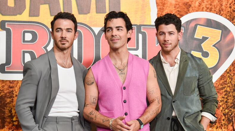 Kevin Jonas, from left, Joe Jonas, and Nick Jonas arrive at the premiere of "Camp Rock 3" on Monday, Aug. 10, 2026, at The Walt Disney Studios in Burbank, Calif. (Photo by Richard Shotwell/Invision/AP)