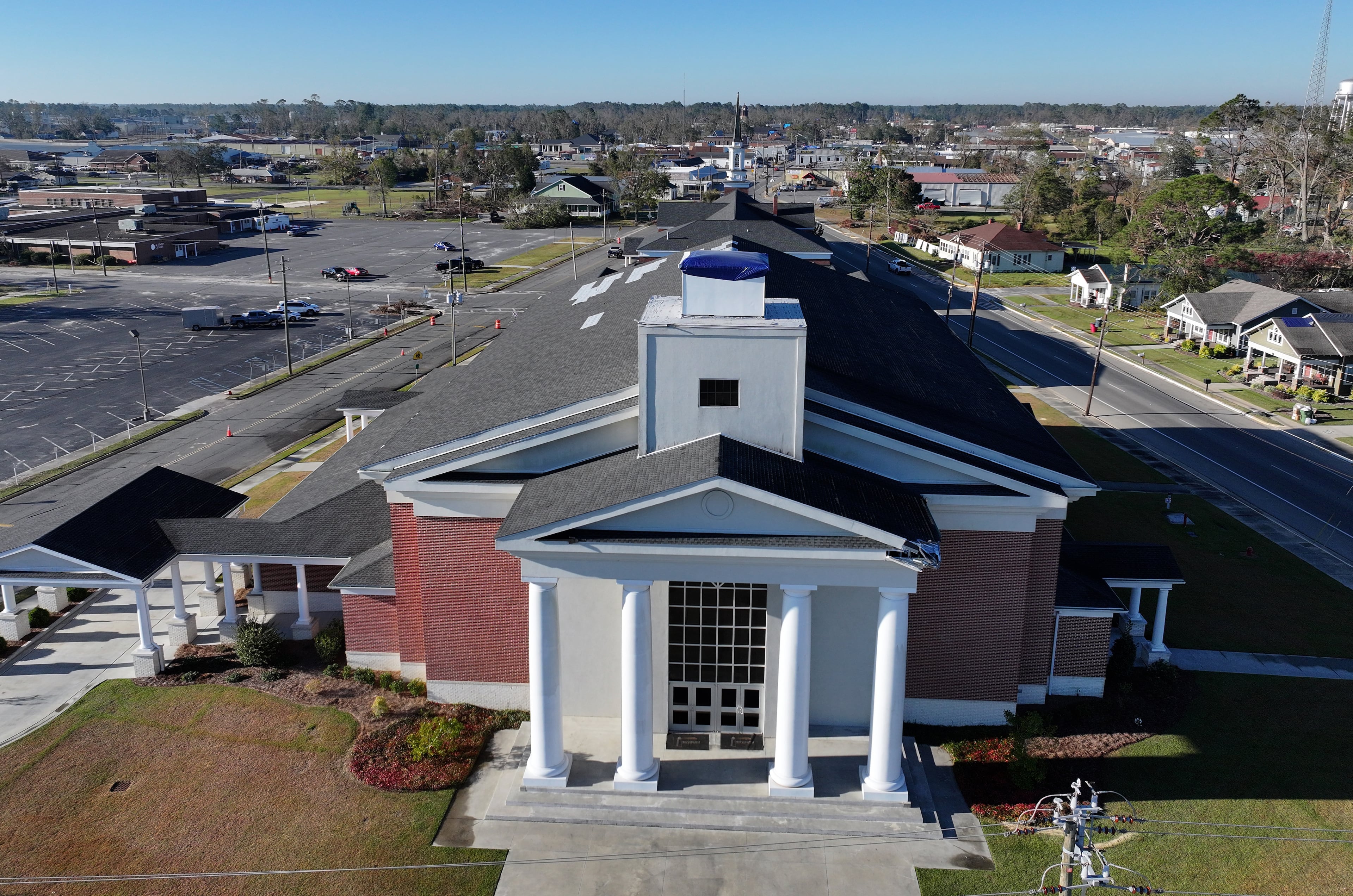 The First Baptist Church in Hazlehurst — pictured here about a month after Hurricane Helene — suffered damage to its roof during the storm, including losing the large steeple at its main entrance. (Hyosub Shin/AJC 2024)