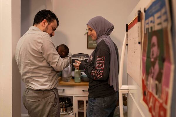 Pro-Palestinian activist Mahmoud Khalil and his wife, Dr. Noor Abdalla, hold their baby Deen during an interview, July 3, 2025, in New York. (AP Photo/Yuki Iwamura)