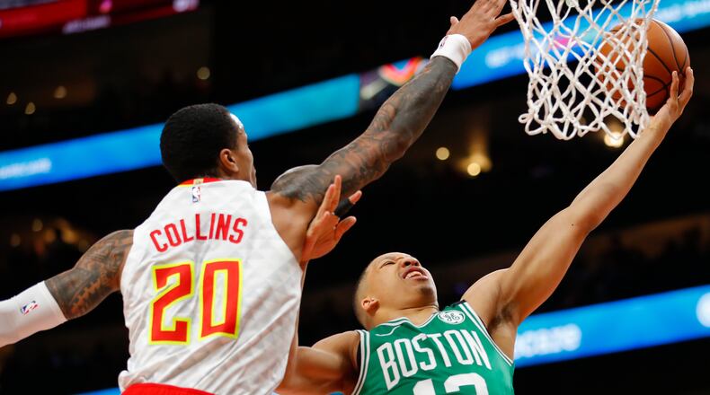Celtics forward Grant Williams (12) goes up for the shot as Hawks forward John Collins (20) defends in the first half of an NBA basketball game on Monday, Feb. 3, 2020, in Atlanta. (AP Photo/Todd Kirkland)