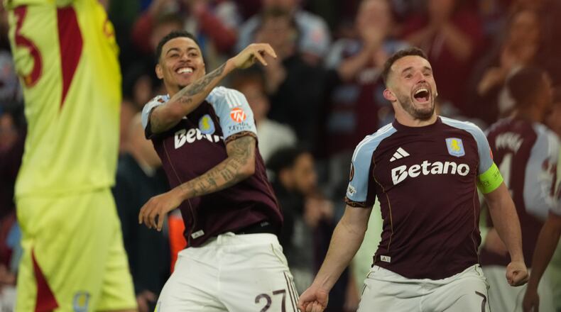 Aston Villa's John McGinn, right, and Morgan Rogers react after the Europa League second-leg semifinal soccer match between Aston Villa and Nottingham Forest in Birmingham, England, Thursday, May 7, 2026. (AP Photo/Dave Shopland)