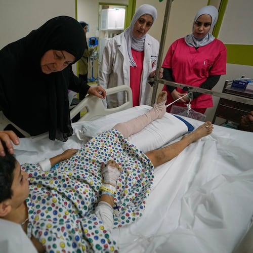 Mustafa Farhat, 8, who was injured in an Israeli airstrike that hit his home and killed his parents, is comforted by his grandmother at a hospital in the town of Nabatiyeh, southern Lebanon, Monday, Sept. 7, 2026. (AP Photo/Mohammed Zaatari)