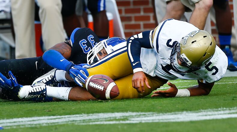 Georgia Tech quarterback Justin Thomas (5) fumbles the ball as he is tackled by Duke safety Deondre Singleton (33) in the second half of an NCAA college football game Saturday, Oct. 11, 2014, in Atlanta. Duke won 31-25. (AP Photo/John Bazemore) Justin Thomas needs to play better against North Carolina than he did in Duke game. (AP photo)