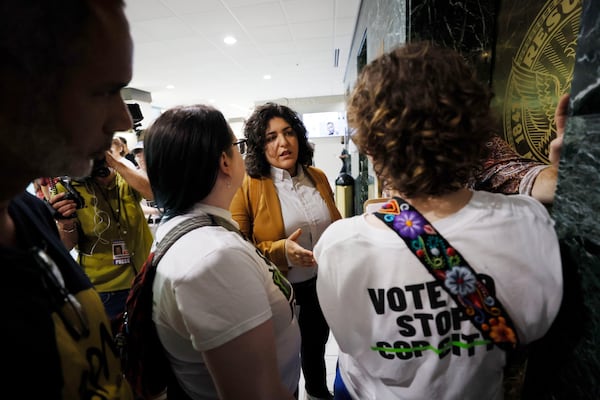 Councilmember Liliana Bakhtiari (center) speaks with opponents of Atlanta’s public safety training center after they delivered a petition seeking a referendum on the project in 2023. (Miguel Martinez/AJC) 