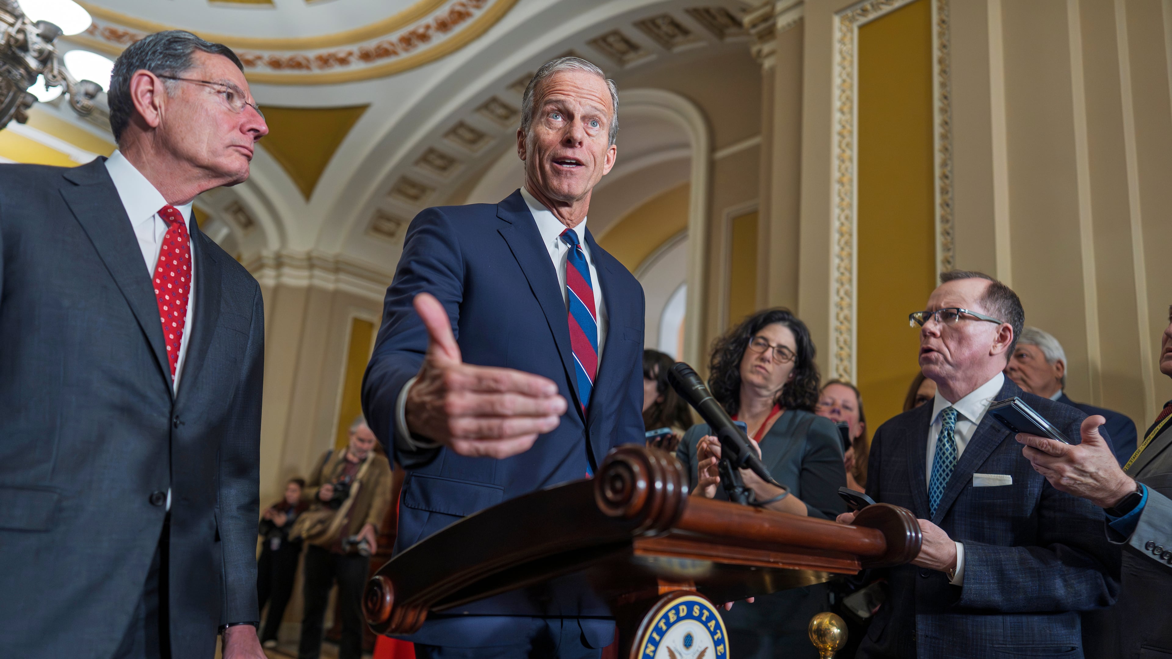 Senate Majority Leader John Thune, R-S.D., joined at left by Sen. John Barrasso, R-Wyo., speaks to reporters after a closed-door meeting with fellow Republicans, at the Capitol in Washington, Tuesday, Dec. 9, 2025. (AP Photo/J. Scott Applewhite)