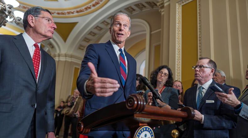 Senate Majority Leader John Thune, R-S.D., joined at left by Sen. John Barrasso, R-Wyo., speaks to reporters after a closed-door meeting with fellow Republicans, at the Capitol in Washington, Tuesday, Dec. 9, 2025. (AP Photo/J. Scott Applewhite)