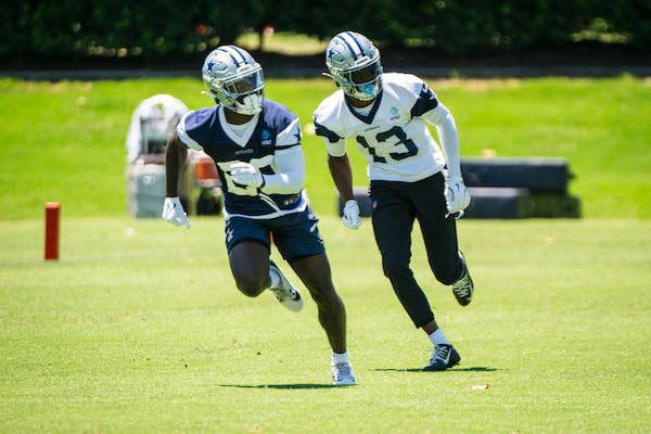 Dallas Cowboys' George Pickens (13) runs a play against teammate Kaiir Elam during NFL football practice at the Cowboys' facility, Tuesday, May 20, 2025, in Frisco, Texas. (AP Photo/Jessica Tobias)