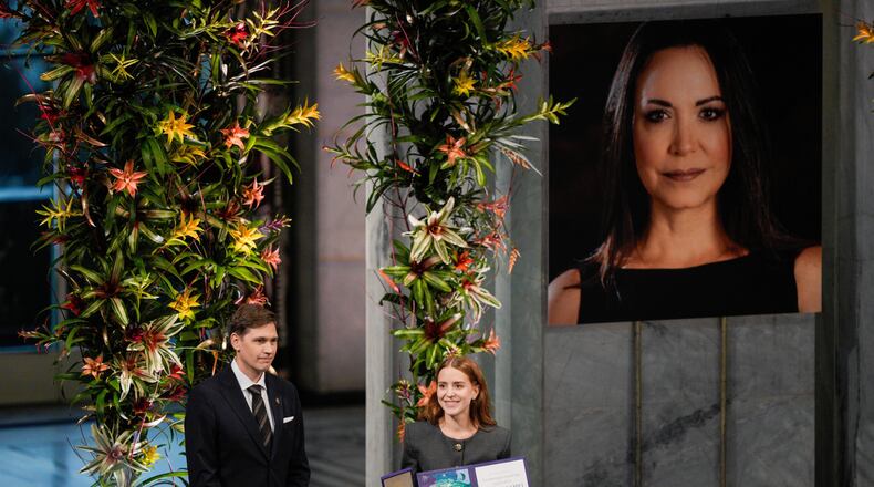 The daughter of the Nobel Peace Prize laureate, Ana Corina Sosa, accepts the award on behalf of her mother, Venezuelan opposition leader Maria Corina Machado, during the Nobel Peace Prize ceremony at Oslo City Hall, Norway, Wednesday Dec. 10, 2025. (Stian Lysberg Solum/NTB Scanpix via AP)
