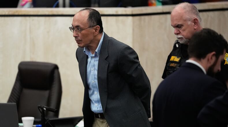 Chikei Rick Chow, left, accused in the 2023 fatal shooting of a Black 14-year-old, is escorted in the courtroom during his murder trial, Friday, May 29, 2026, in Columbia, S.C. (AP Photo/Erik Verduzco)