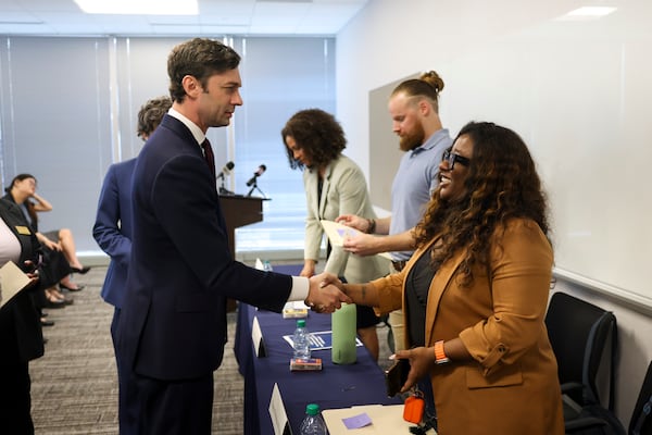 U.S. Jon Ossoff, D-Ga., greeted renter Shana Brooks-Wilhite at an event in Atlanta on Monday.
