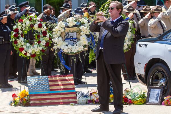 John-Thomas Burson plays Taps after the funeral of Holly Springs Police Officer Joe Burson at First Baptist Church of Woodstock on June 21, 2021.  STEVE SCHAEFER FOR THE ATLANTA JOURNAL-CONSTITUTION