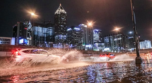 Motorists plow through standing water along Techwood Drive near 16th Street in 2023. (John Spink/AJC 2023)

