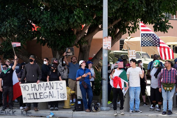 Protesters against federal immigration raids gather outside the Metropolitan Detention Center, Wednesday, June 11, 2025, in Los Angeles. (AP Photo/Damian Dovarganes)
