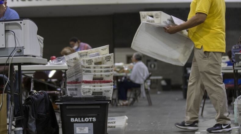 Boxes of mail-in ballots will be recorder by Fulton County employees as they continue to count mail-in ballots the day after the Georgia primary election at the Georgia World Congress Center in Atlanta, June 10. (ALYSSA POINTER / ALYSSA.POINTER@AJC.COM)