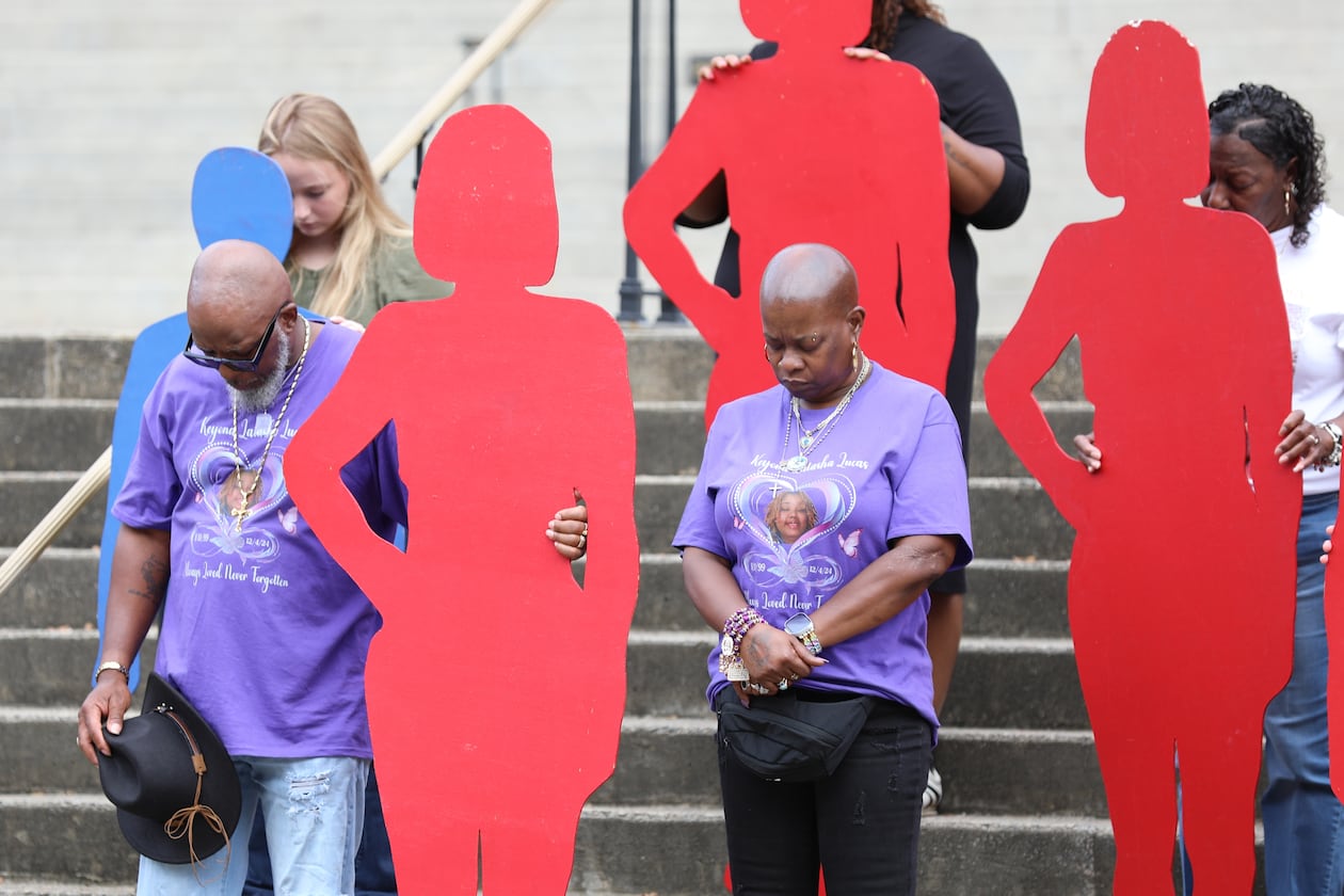 A couple holds up a silhouette of one of the 46 people killed by domestic violence in South Carolina in 2024 at the state Attorney General's Office Silent Witness Ceremony on Tuesday, Oct. 7, 2025, in Columbia, S.C. If we start talking about intimate partner abuse we might finally begin to end it, writes guest columnist Michael Lucas. (Jeffrey Collins/AP)