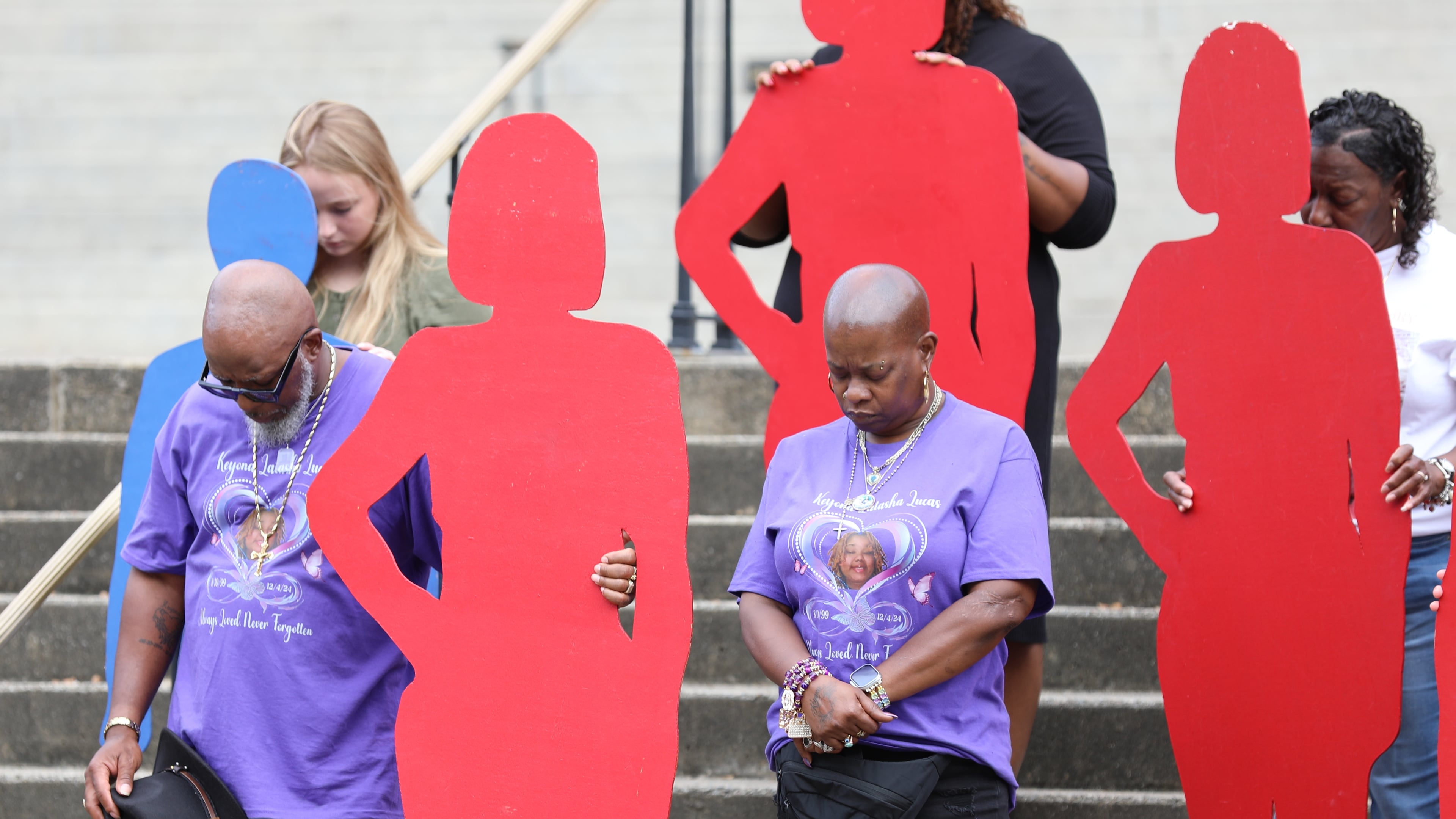 A couple holds up a silhouette of one of the 46 people killed by domestic violence in South Carolina in 2024 at the state Attorney General's Office Silent Witness Ceremony on Tuesday, Oct. 7, 2025, in Columbia, S.C. If we start talking about intimate partner abuse we might finally begin to end it, writes guest columnist Michael Lucas. (Jeffrey Collins/AP)