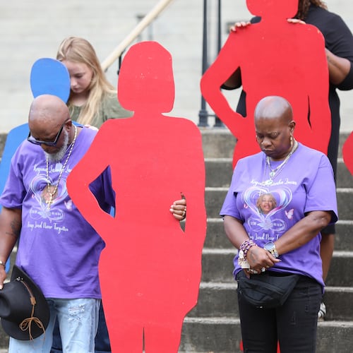 A couple holds up a silhouette of one of the 46 people killed by domestic violence in South Carolina in 2024 at the state Attorney General's Office Silent Witness Ceremony on Tuesday, Oct. 7, 2025, in Columbia, S.C. If we start talking about intimate partner abuse we might finally begin to end it, writes guest columnist Michael Lucas. (Jeffrey Collins/AP)