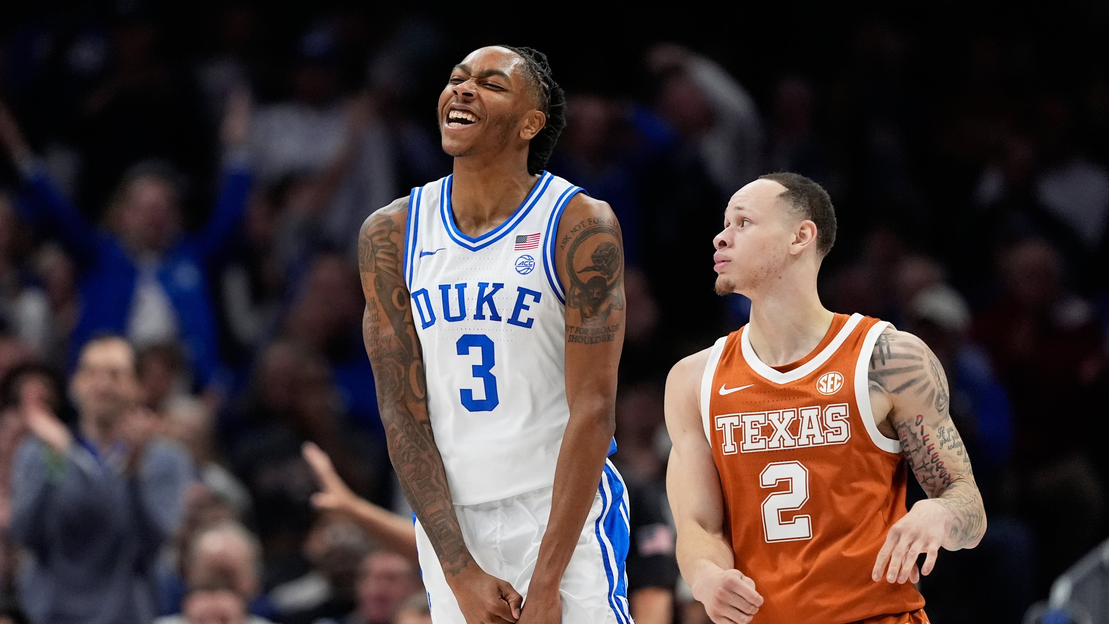 Duke guard Isaiah Evans celebrates after scoring as Texas guard Chendall Weaver looks on during the first half of an NCAA college basketball game, Tuesday, Nov. 4, 2025, in Charlotte, N.C. (AP Photo/Chris Carlson)