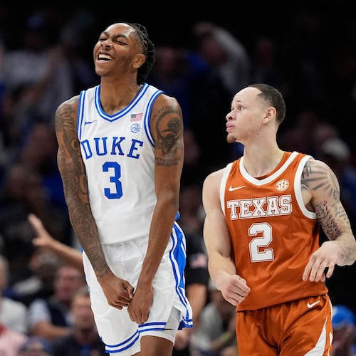 Duke guard Isaiah Evans celebrates after scoring as Texas guard Chendall Weaver looks on during the first half of an NCAA college basketball game, Tuesday, Nov. 4, 2025, in Charlotte, N.C. (AP Photo/Chris Carlson)