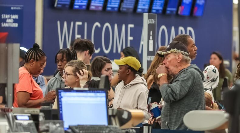 Passengers seek assistance at Delta ticket counters at Hartsfield-Jackson International Airport on Wednesday, July 24, 2024. (John Spink / John.Spink@ajc.com)