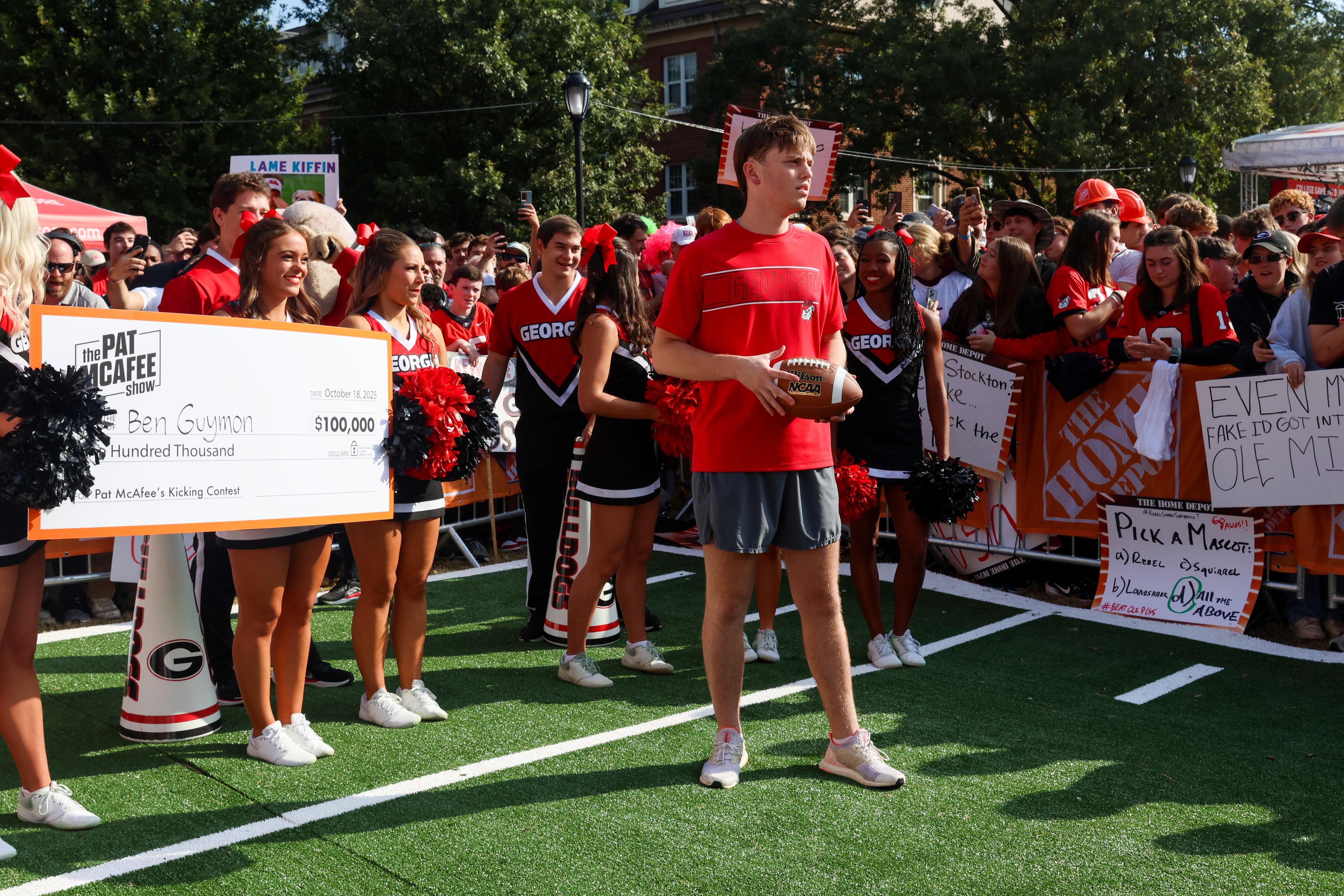Ben Guymon (center) prepares to compete for $100,000 during Pat McAfee’s Kicking Contest during the ESPN College GameDay broadcast from Myers Quad at UGA on Saturday, Oct. 18, 2025. Guymon missed on his first try but made a second kick during the commercial break. (C.J. Bartunek for the AJC)