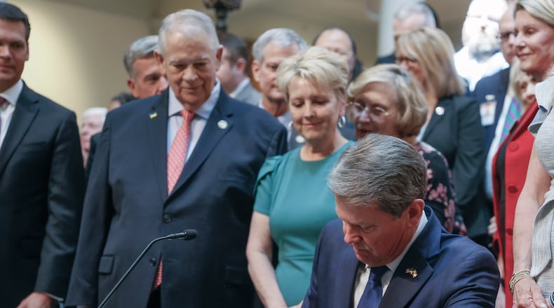 With much fanfare, Gov. Brian Kemp signs HB 1013, which aims to increase access to mental health coverage in Georgia on Sine Die, the last day of the General Assembly at the Georgia State Capitol in Atlanta on Monday, April 4, 2022. (Bob Andres / robert.andres@ajc.com)