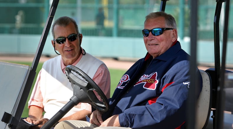 Feb. 20, 2012- LAKE BUENA VISTA, FL: Atlanta Braves president John Schuerholz, left, talks with former manager Bobby Cox as they watch the first day of pitchers and catchers workouts at Champion Stadium in the ESPN Wide World of Sports Complex Monday morning in Lake Buena Vista, Fl., Feb. 20, 2012. Jason Getz jgetz@ajc.com