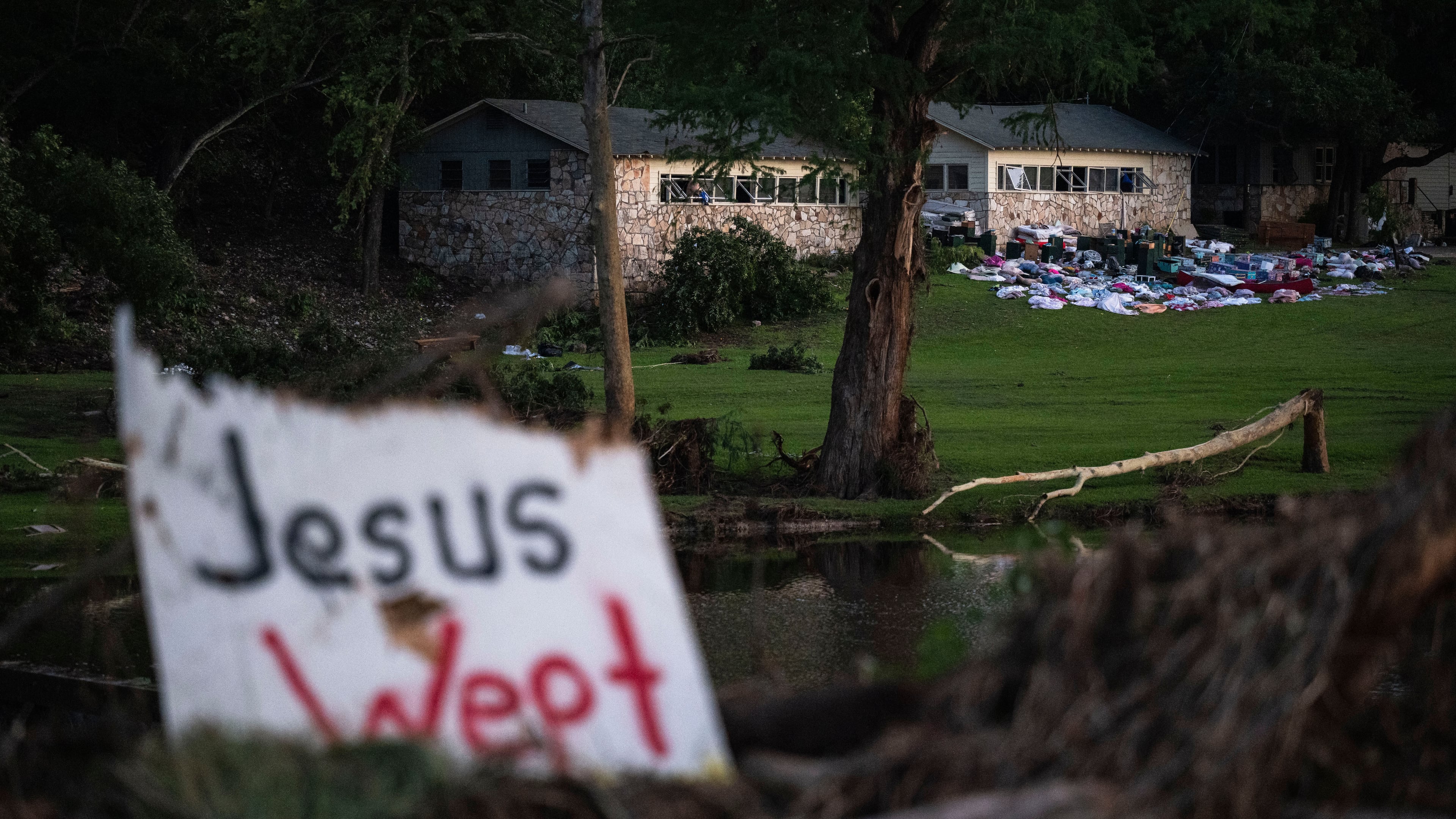 FILE - Campers belongings sit outside one of Camp Mystic's cabins near the Guadalupe River, July 7, 2025, in Hunt, Texas, after a flash flood swept through the area. (AP Photo/Eli Hartman, File)