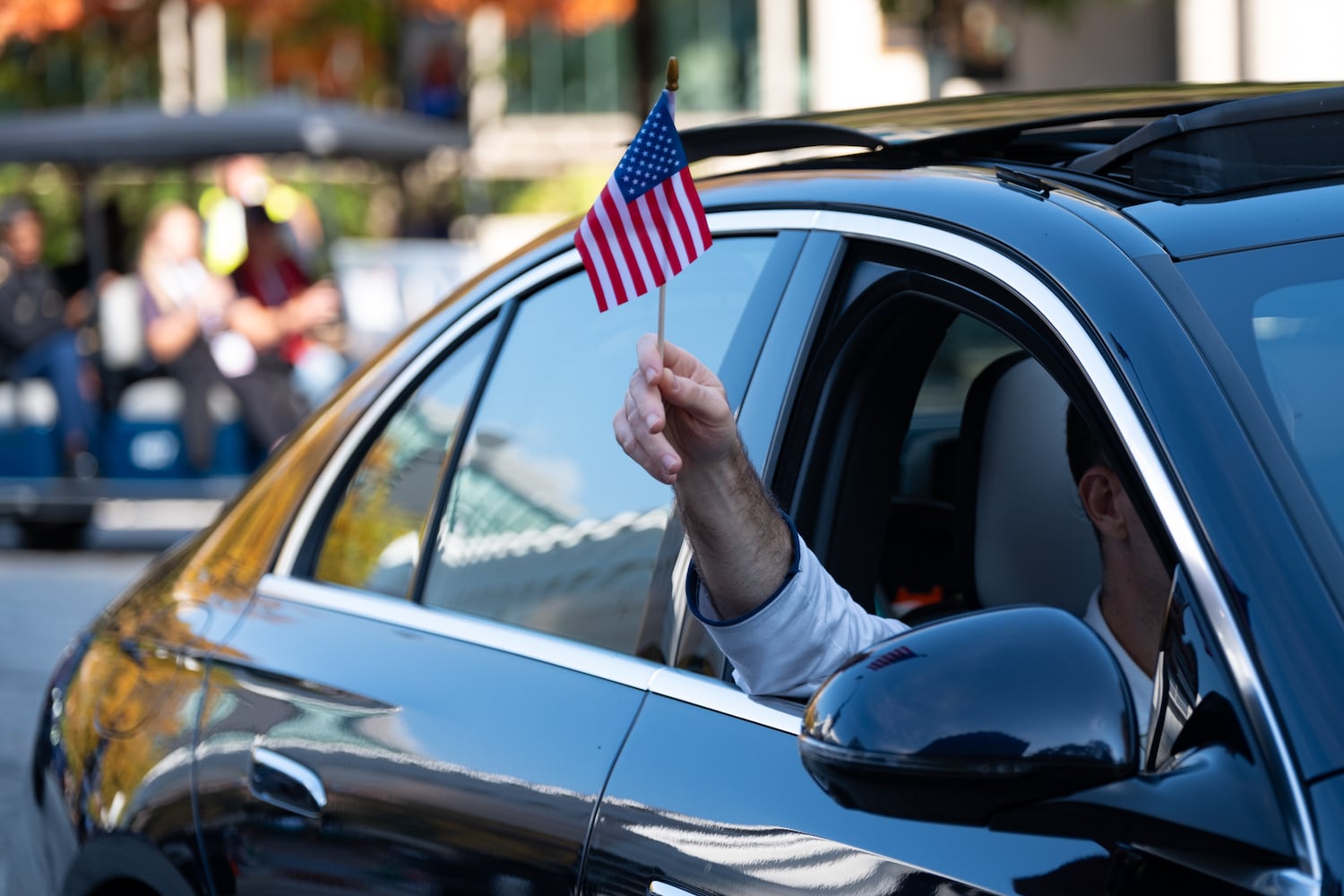 A participant waves a flag during the Georgia Veterans Day Parade in Midtown Atlanta on Saturday, Nov. 8, 2025.   Ben Gray for the Atlanta Journal-Constitution