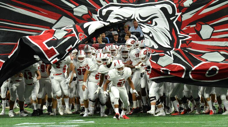 North Gwinnett football players run onto the field before the start of their game against the Brookwood at the Corky Kell Classic Saturday, Aug. 18, 2018, at Mercedes-Benz Stadium in Atlanta.