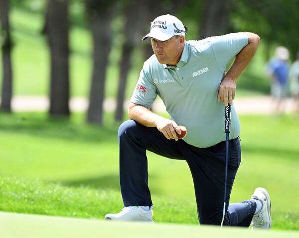 Padraig Harrington eats an apple while lining up a putt on the 10th hole on the first day at the U.S. Senior Open Championship at Broadmoor Golf Club in Colorado Springs, Colo., Thursday, June 26, 2025. (Jerilee Bennett/The Gazette via AP)