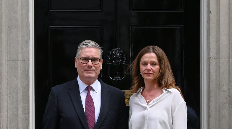 Britain's Prime Minister Keir Starmer and wife Victoria stand in front of 10 Downing Street door after after announcing his resignation in London, Monday, June 22, 2026.(AP Photo/Thomas Krych)