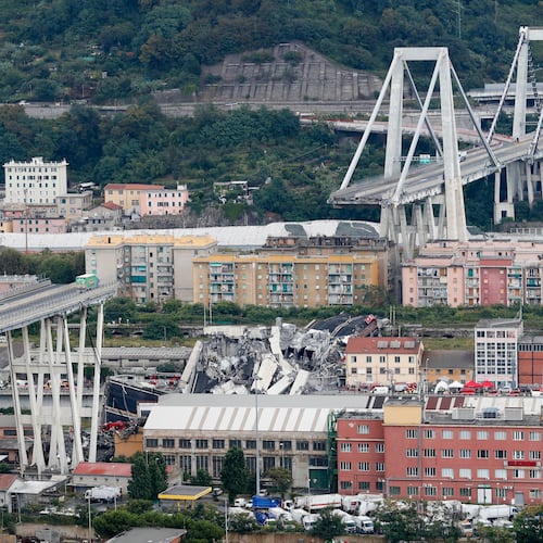 FILE - Cars are blocked on the Morandi highway bridge after a section of it collapsed, Aug. 14, 2018, in Genoa, northern Italy. (AP Photo/Antonio Calanni, File)