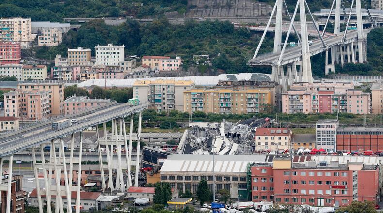 FILE - Cars are blocked on the Morandi highway bridge after a section of it collapsed, Aug. 14, 2018, in Genoa, northern Italy. (AP Photo/Antonio Calanni, File)