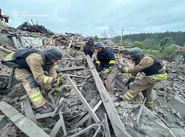 In this photo provided by the Ukrainian Emergency Service, firefighters search for victims following a Russian air attack in Zhitomir region, Ukraine, Sunday, May 25, 2025. (Ukrainian Emergency Service via AP)