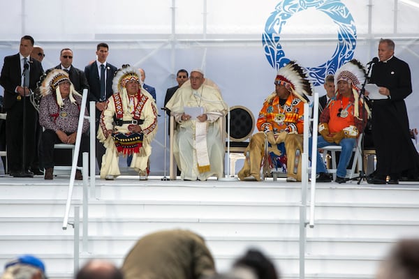 FILE - People listen to Pope Francis issue a historic apology for the Catholic Church's cooperation with Canada's "catastrophic" policy of Indigenous residential schools in Maskwacis, near Edmonton, Canada, July 25, 2022. (AP Photo/Ted Shaffrey, File)
