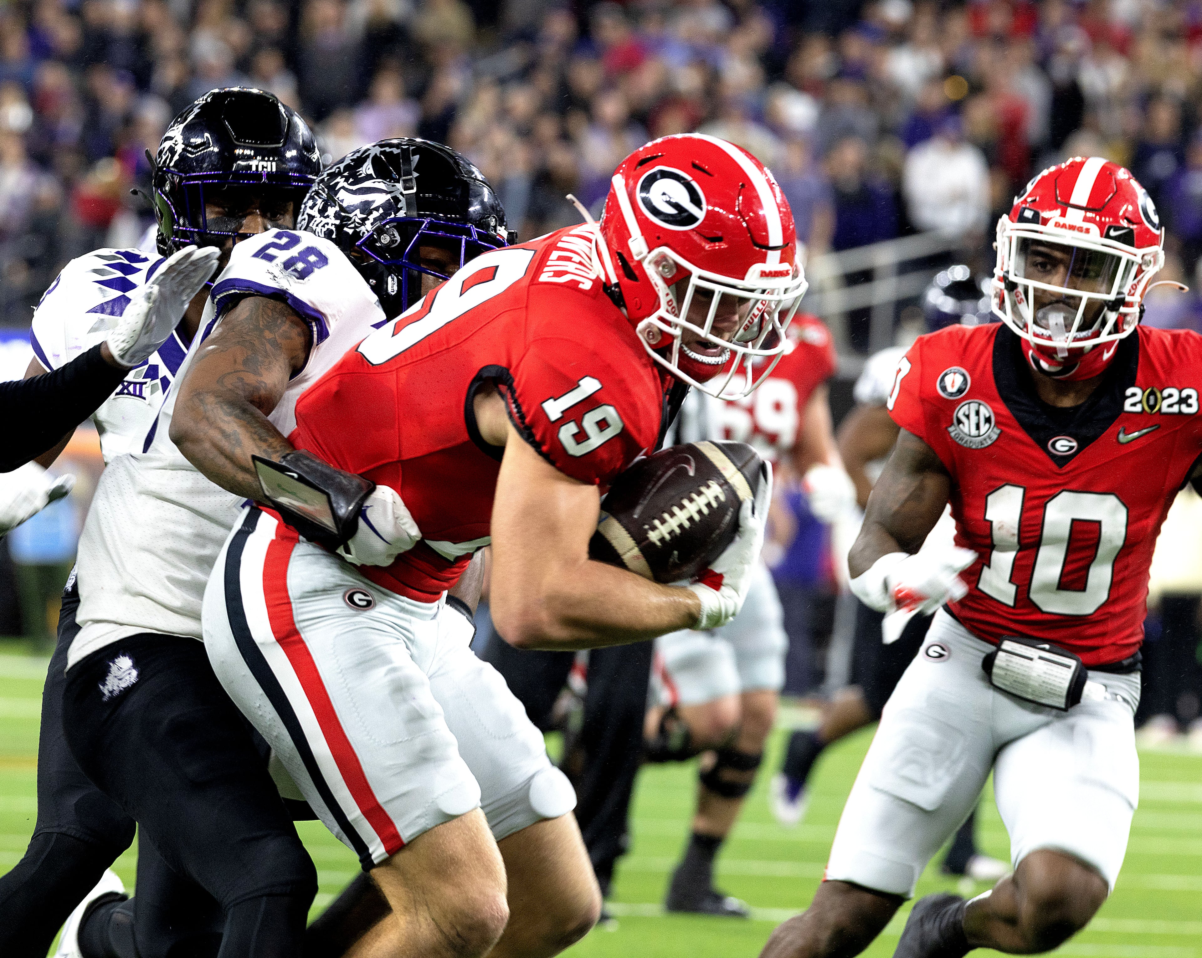Former Georgia tight end Brock Bowers (center), shown here during the 2023 College Football Playoff national championship game, set team and league records last season in his rookie campaign with the Las Vegas Raiders. (AJC 2023)