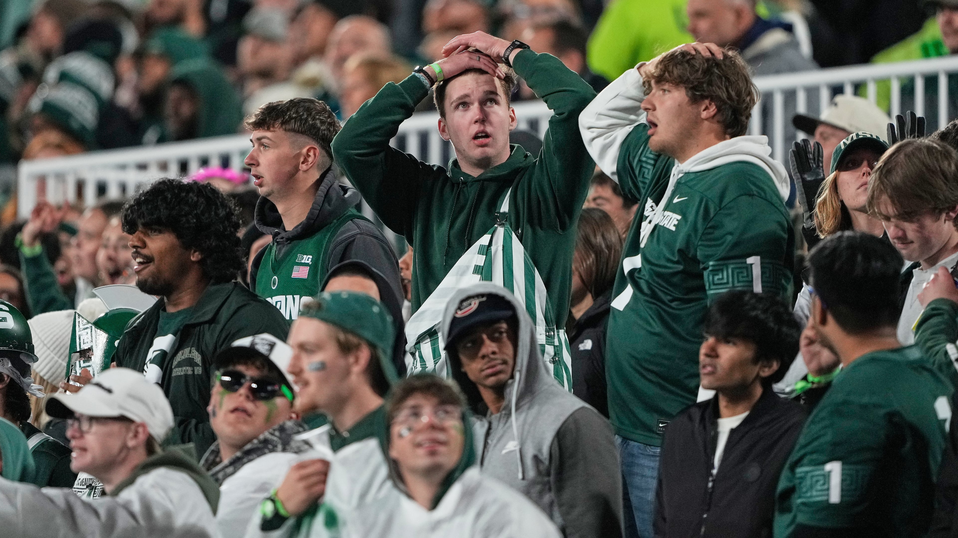 Michigan State fans react during the first half of an NCAA college football game against Michigan Saturday, Oct. 25, 2025, in East Lansing, Mich. (AP Photo/Ryan Sun)