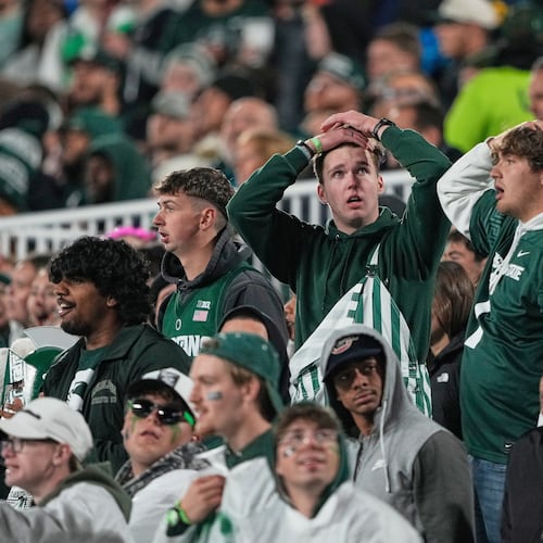 Michigan State fans react during the first half of an NCAA college football game against Michigan Saturday, Oct. 25, 2025, in East Lansing, Mich. (AP Photo/Ryan Sun)