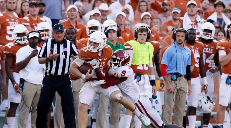 Texas quarterback Sam Ehlinger is tackled by Oklahoma linebacker Kenneth Murray during their game in 2017.
