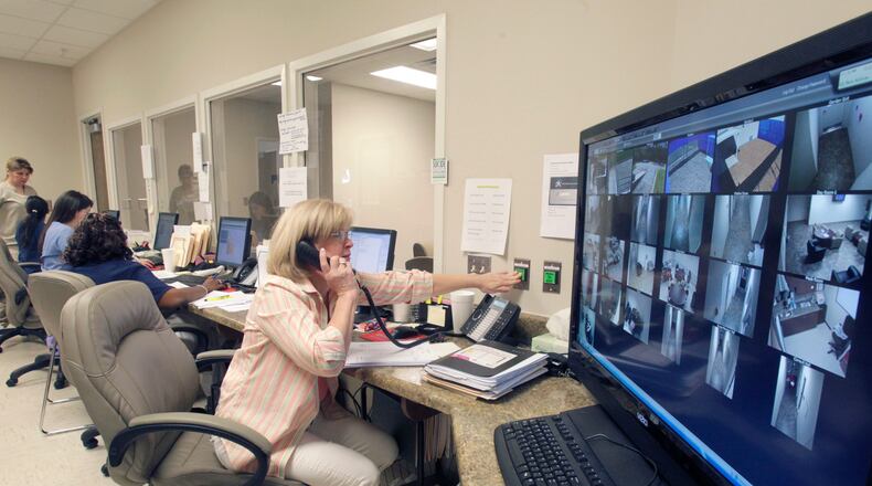 110407 - Flowery Branch - Michele Morris, program assistant, watches over patients from the nurses station. Most of the areas are also monitored via closed circuit TV. Avita Community Partners, a non-profit organizaton that serves persons with behavioral health, developmental disabilities and addictive diseases in North Georgia, operates this new 16 bed Crisis Stabilazation Unit opened by the state Department of Behavioral Health and Developmental Disabilities in North Georgia's Flowery Branch community. Bob Andres bandres@ajc.com