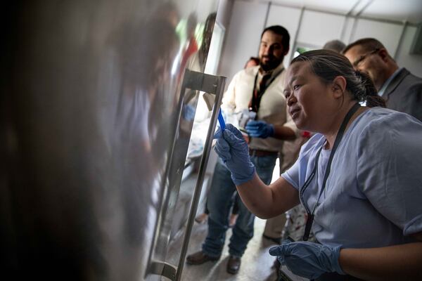 Jody Sanmuen practices conducting "environmental sampling" on a food truck refrigerator at the Association of Food and Drug workshop at the Grand Hyatt Atlanta on Saturday, June 22, 2019. (Photo: BRANDEN CAMP/SPECIAL TO THE AJC)