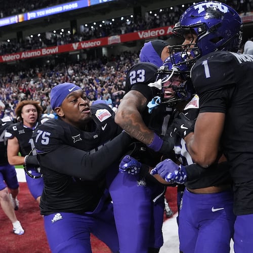 TCU running back Jeremy Payne, center, celebrates with teammates after he ran for a touchdown against Southern California during overtime in the Alamo Bowl NCAA college football game in San Antonio, Tuesday, Dec. 30, 2025. (AP Photo/Eric Gay)