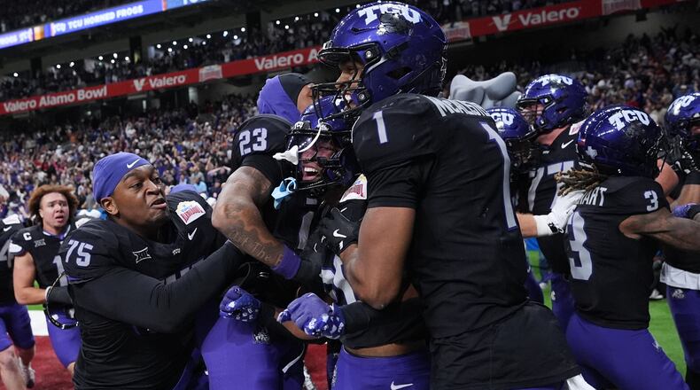 TCU running back Jeremy Payne, center, celebrates with teammates after he ran for a touchdown against Southern California during overtime in the Alamo Bowl NCAA college football game in San Antonio, Tuesday, Dec. 30, 2025. (AP Photo/Eric Gay)