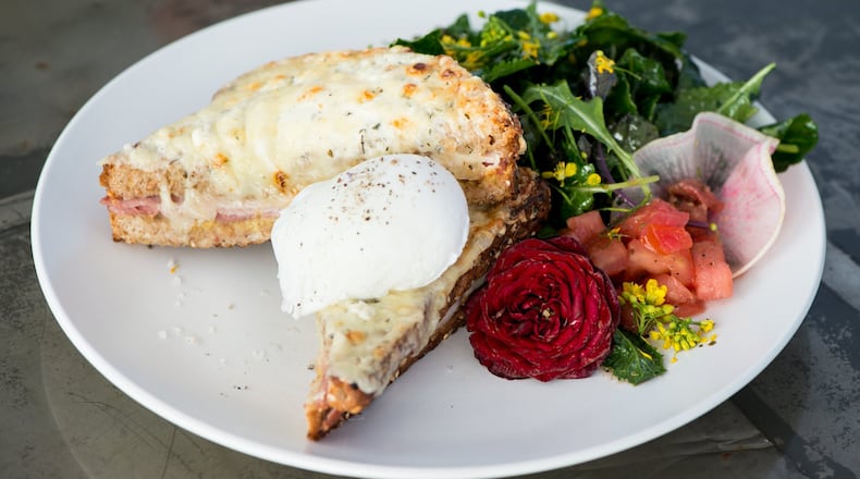 Petit Chou’s Croque Madame is a grilled ham and cheese melt topped with Gruyere and a poached egg. CONTRIBUTED BY MIA YAKEL