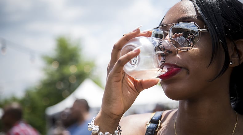 A woman drinks wine at a festival in Atlanta. CONTRIBUTED BY RAFTERMEN / AFWF
