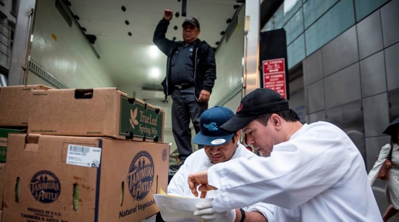 Guillermo Vargas and Kelby Vargas, from restaurant Le Cirque, check a delivery ordered through the online marketplace Dine Market, in New York, Nov. 10, 2015. A small but growing number of famous restaurateurs are using Dine Market’s technology, which allows restaurants big and small to compare prices and order food supplies from more than 100 vendors, to streamline the way they buy food.