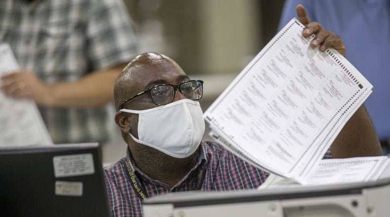 Fulton County employees continue to count mail-in ballots the day after the Georgia primary election at the Georgia World Congress Center in Atlanta, Wednesday, June 10, 2020. A spokesperson for Fulton County said that they will announce the final number of mail-in ballots on Wednesday. (ALYSSA POINTER / ALYSSA.POINTER@AJC.COM)