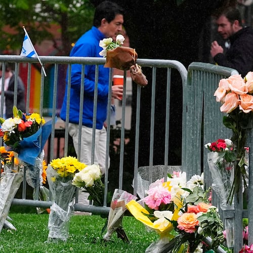 FILE - Bouquets of flowers stand along a makeshift memorial for victims of an attack outside of the Boulder County courthouse on June 3, 2025, in Boulder, Colo. (AP Photo/David Zalubowski, file)